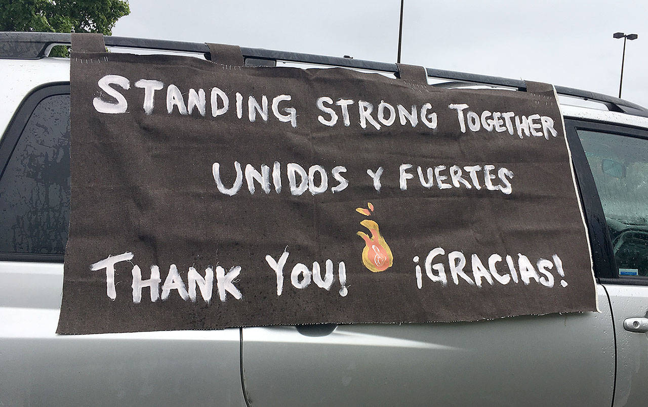 COURTESY PHOTO                                 One of the banners on a vehicle in the caravan that paraded through the county May 2 to thank essential workers. The event was organized by Firelands Workers United.