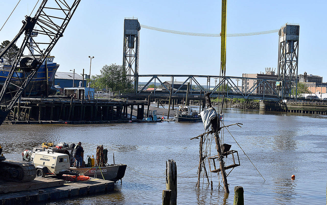 DAN HAMMOCK | GRAYS HARBOR NEWS GROUP                                 The mast of the Lady Grace appears above the surface of the Hoquiam River as crews from Associated Underwater Services and Quigg Bros. attempt to winch the vessel off the bottom Thursday morning.