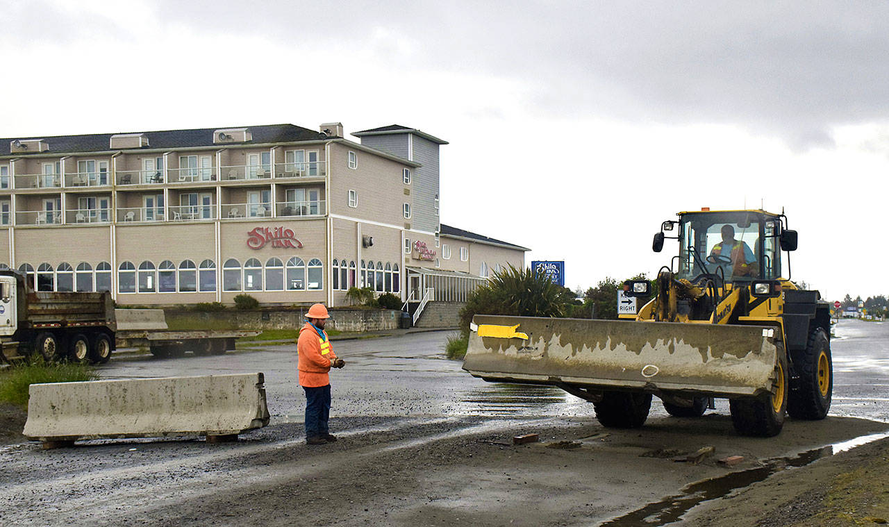 Ocean Shores city workers were out Tuesday morning removing the concrete highway barriers, including these at Chance a la Mer Boulevard. Some Ocean Shores hotels now how the green light to open this Tuesday. (Photo by Scott D. Johnston)
