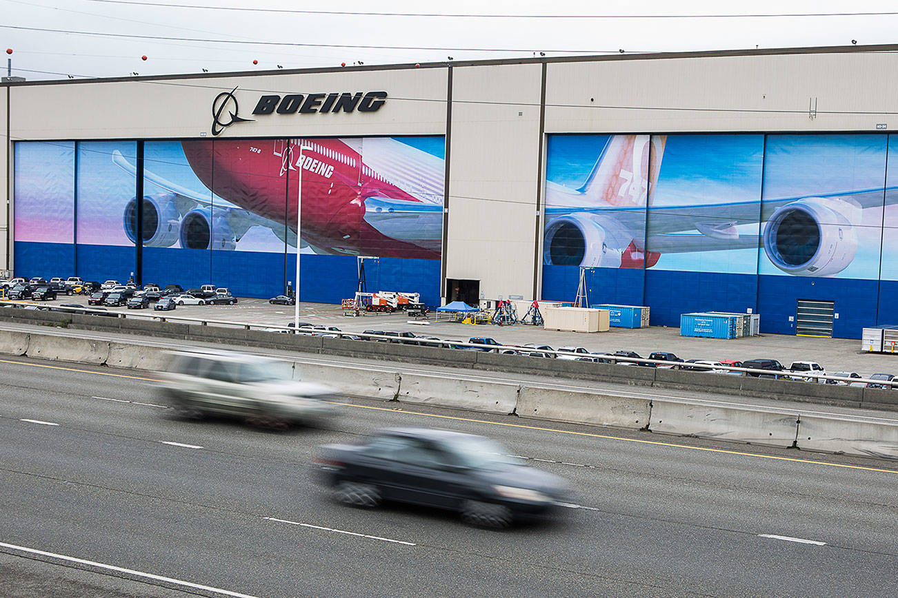 Cars drive by Boeing’s Everett assembly plant on Tuesday, April 21, 2020 in Everett, Wa. (Olivia Vanni / The Herald)