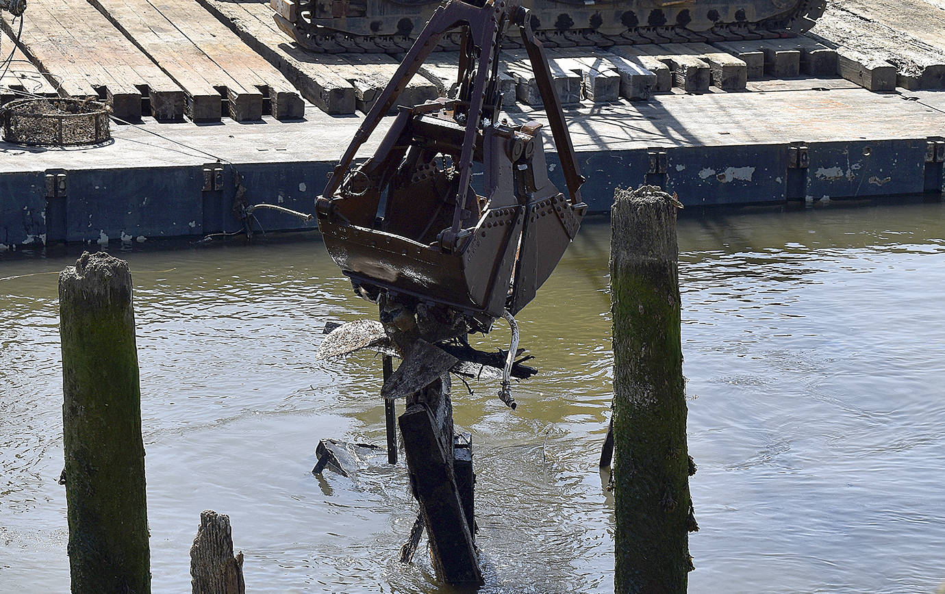 DAN HAMMOCK | GRAYS HARBOR NEWS GROUP                                 A crane bucket grabs a prop on the Lady Grace Wednesday. At times large sections of the 80-foot fishing vessel, sunk in the Hoquiam River two years ago, were visible, but the Grace was coming out of the river Wednesday in pieces.