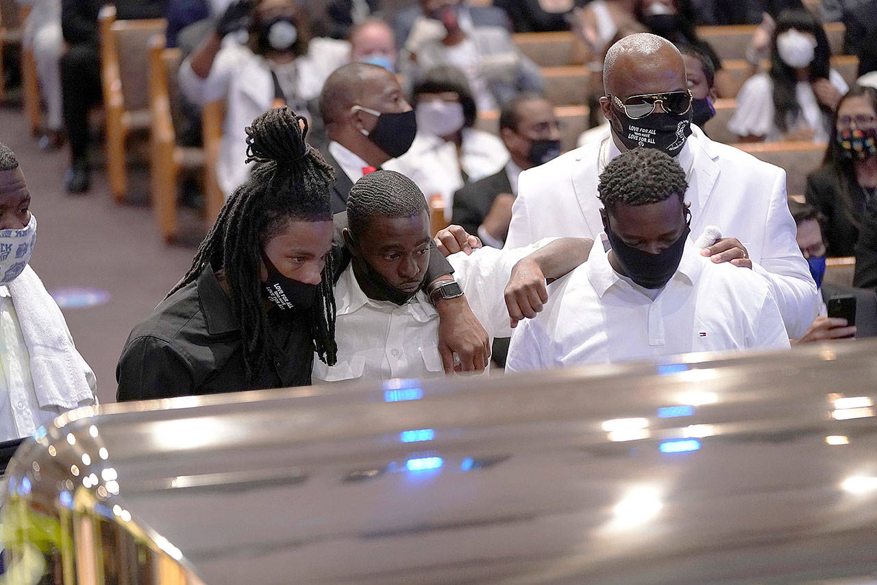 Mourners pause at the casket bearing the remains of George Floyd in the chapel during his funeral service at the Fountain of Praise church Tuesday in Houston, Texas. Floyd died May 25 while in Minneapolis police custody, sparking nationwide protests. (David J. Phillip/Getty Images)