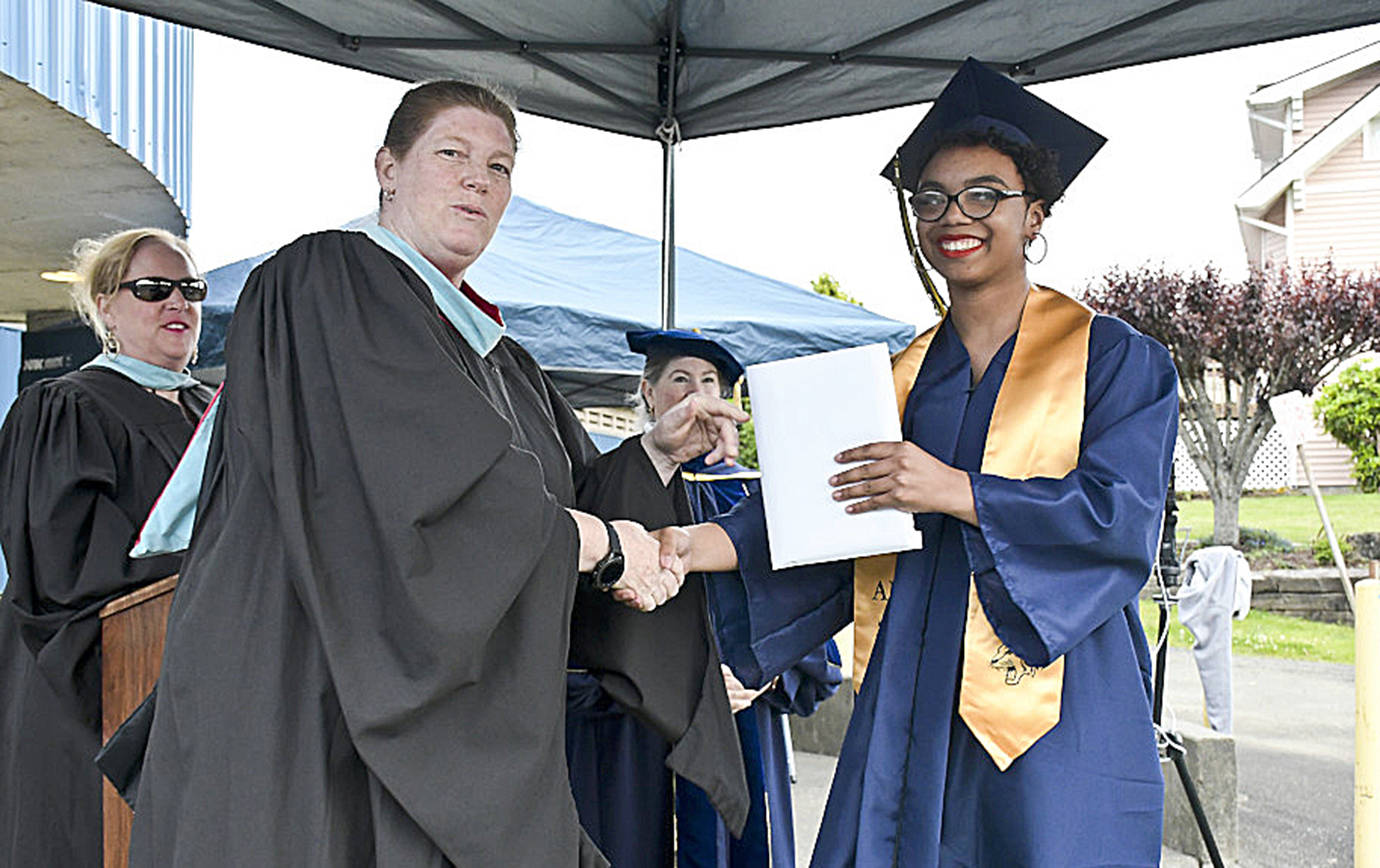 DARRELL WESTMORELAND PHOTO                                 Aberdeen High School Class of 2020 graduate Issabella Gilford shakes hands with Principal Sherri Northington at the graduation ceremony at Stewart Field June 12.