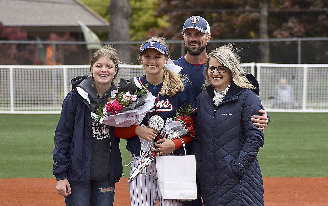 DAN HAMMOCK | GRAYS HARBOR NEWS GROUP                                Britney Patrick from Pe Ell-Willapa Valley stands on the pitchers mound with her parents as seniors were honored at Montesano’s softball game Wednesday. Just minutes earlier she signed her letter-of-intent to play for St. Martin’s University.