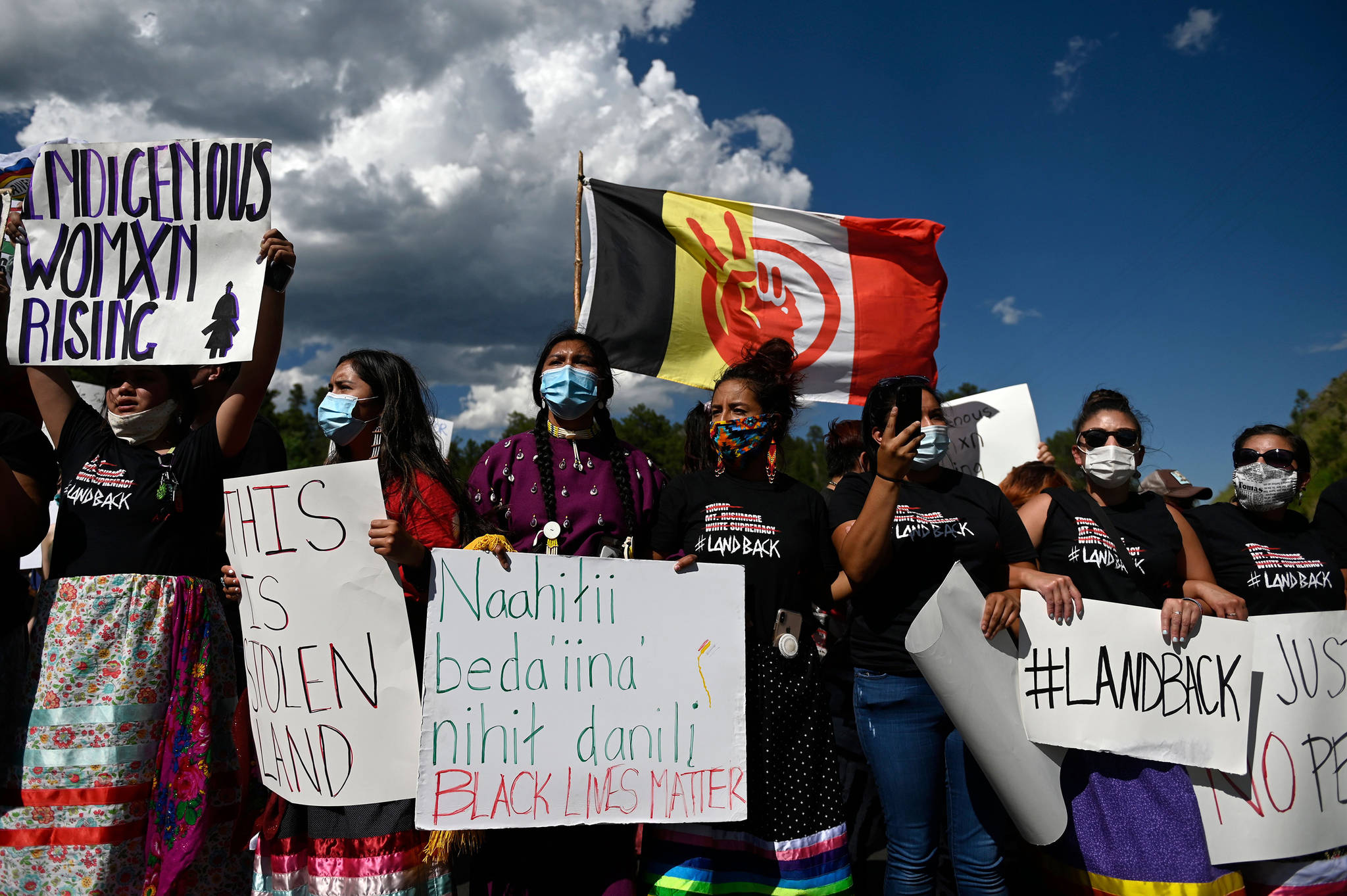 Activists and members of different tribes from the region block the road to Mount Rushmore National Monument as they protest in Keystone, South Dakota on July 3, 2020, during a demonstration around the Mount Rushmore National Monument and the visit of US President Donald Trump. (Andrew Caballero-Reynolds/AFP/Getty Images/TNS)