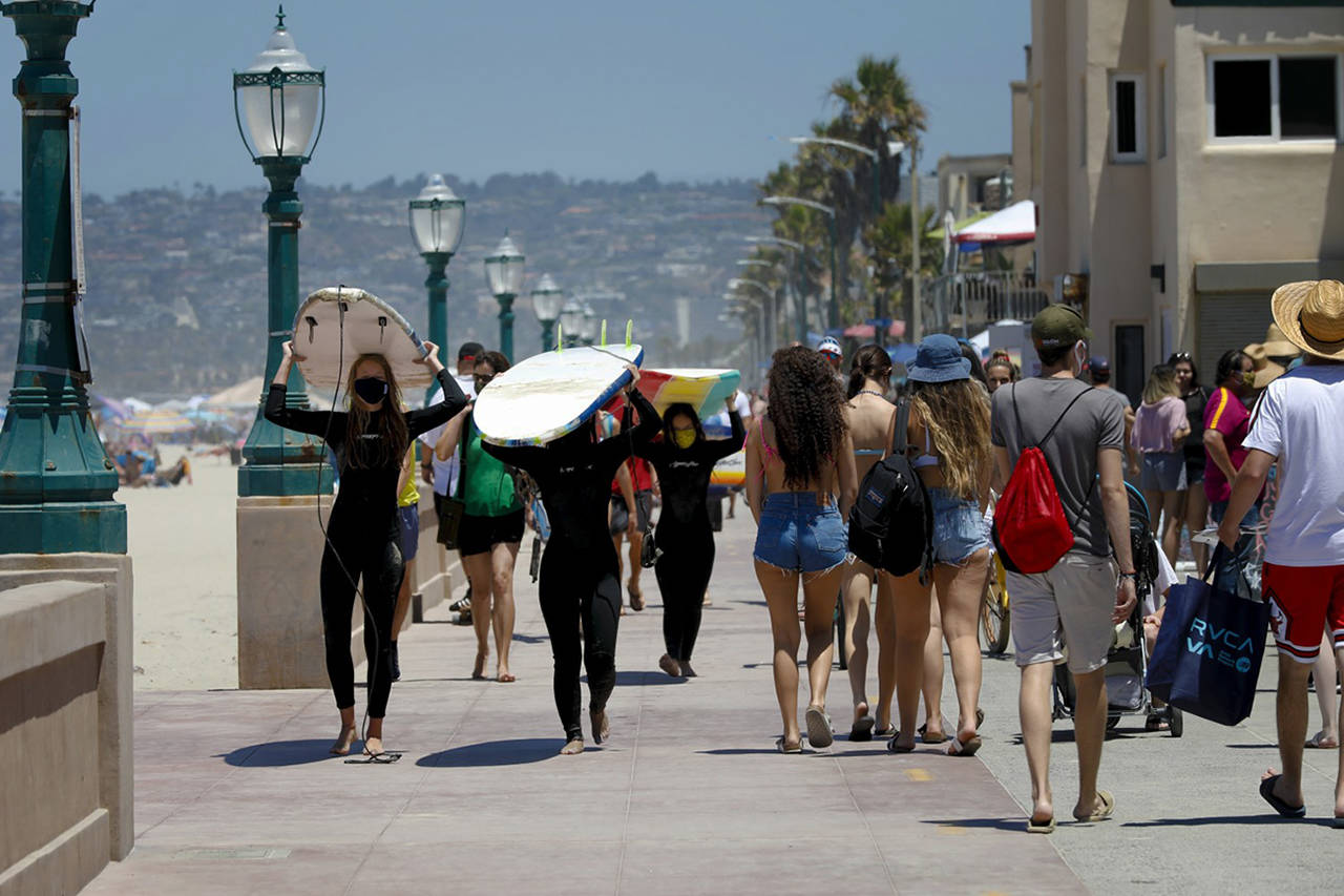 Nelvin C. Cepeda | Los Angeles Times                                The boardwalk at San Diego’s Mission Beach was full of holiday locals, surfers and tourists during the Fourth of July weekend. Because of the coronavirus pandemic, the typical holiday crowd appeared to be thinner than in previous years.