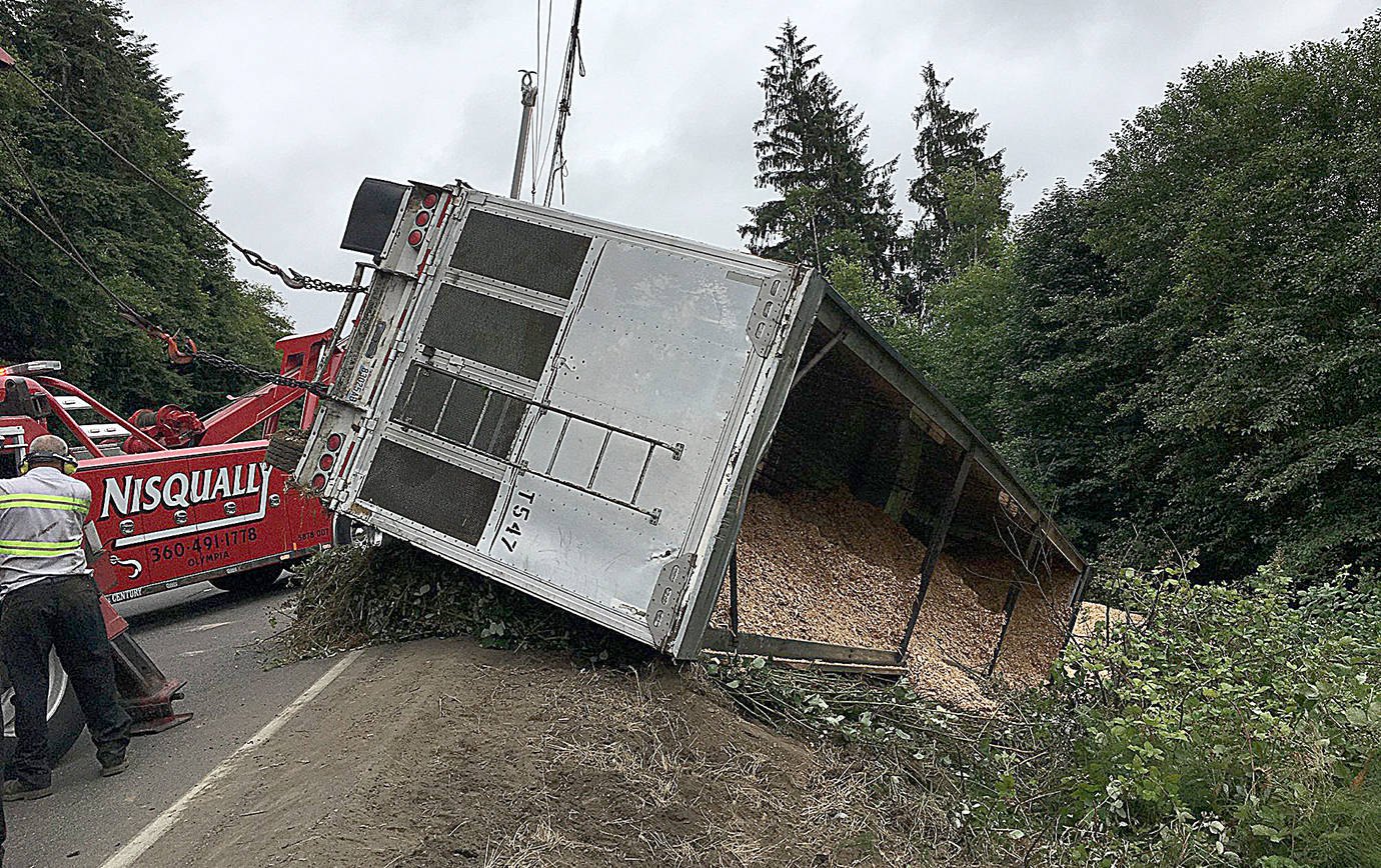 WSDOT PHOTO                                 Crews remove a chip truck that crashed on eastbound Highway 12 at Baila Dip just east of Aberdeen.