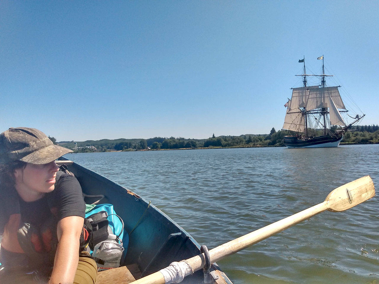 Heather (Margot) Longfellow rows in Grays Harbor while sharing the waters with the Lady Washington in late July. (Ryan Hashagen photo)