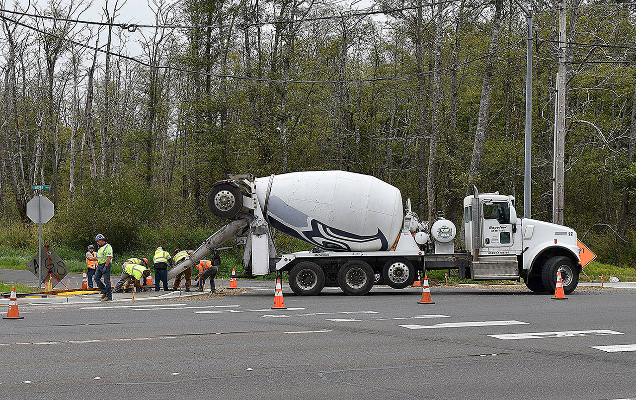 DAN HAMMOCK | GRAYS HARBOR NEWS GROUP                                 Crews from Ronglins Inc. pour an ADA sidewalk ramp at the corner of South Boone and West Huntley streets in south Aberdeen Friday, part of the citys Grays Harbor College Neighborhood Connection project.