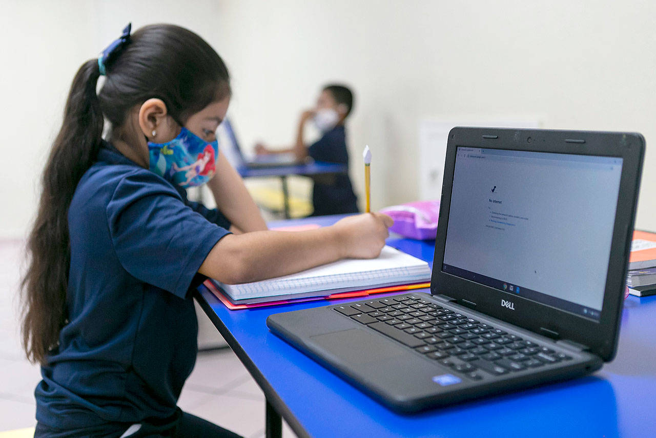 Sarai Machic, 8, attends Miami Community Charter School in Flagler City, Fla. for the first day of class on Monday. Miami Community Charter is one of the few schools accommodating students who do not have Internet access at home or whose parents cannot stay home with them for remote learning. (Matias J. Ocner/Miami Herald)