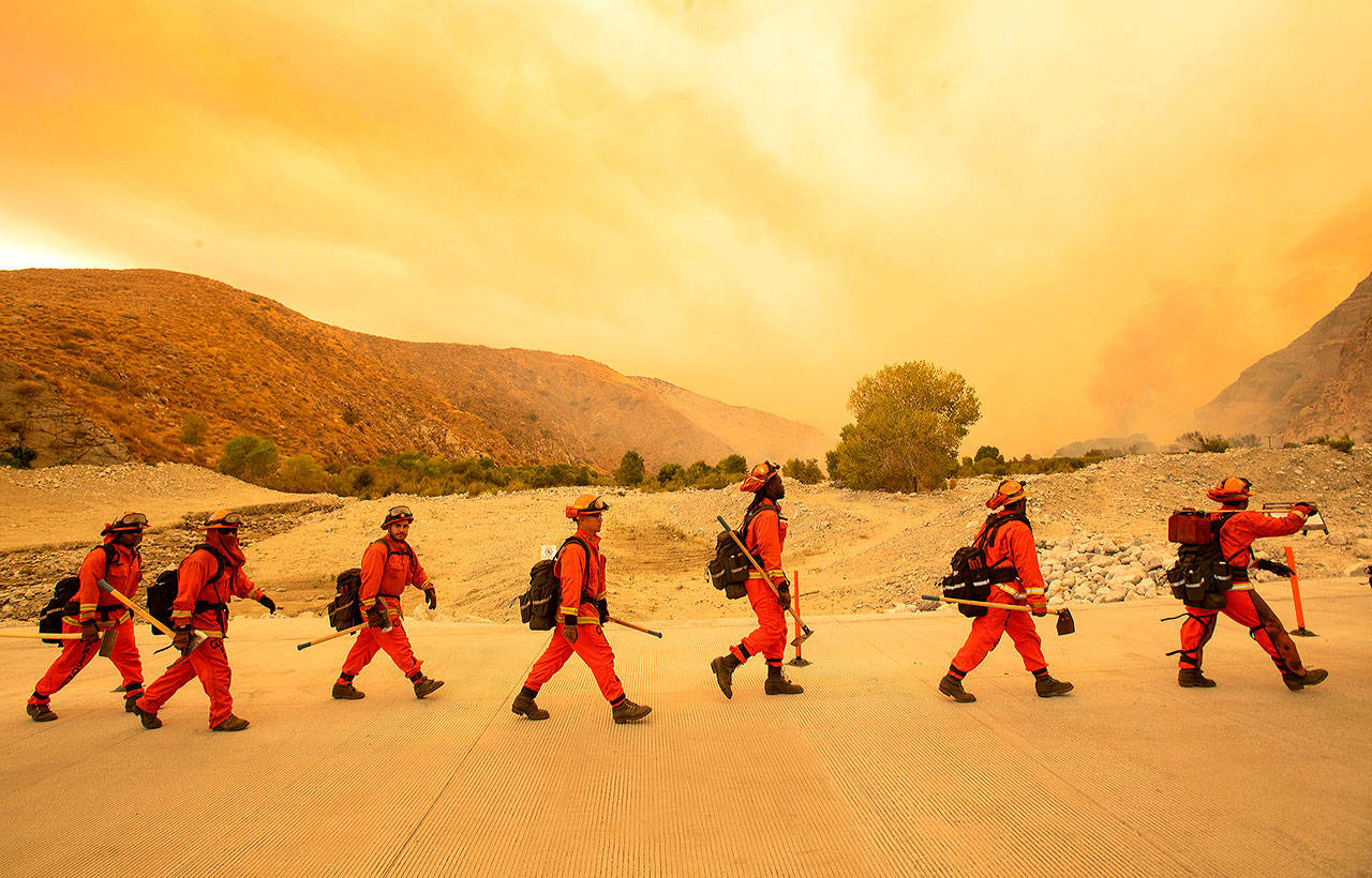 Inmate firefighters arrive at the scene of the Water fire, a new start about 20 miles from the Apple fire in Whitewater, California. (Josh Edelson/Getty Images)