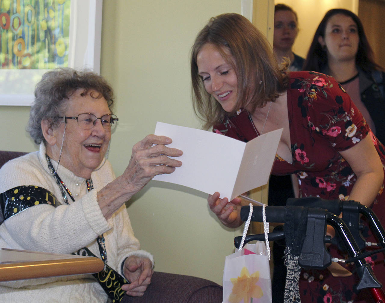 Photo by Dee Anne Shaw                                Ruth McCausland receives a 100th birthday card from granddaughter Meghan McCausland in July 2019.