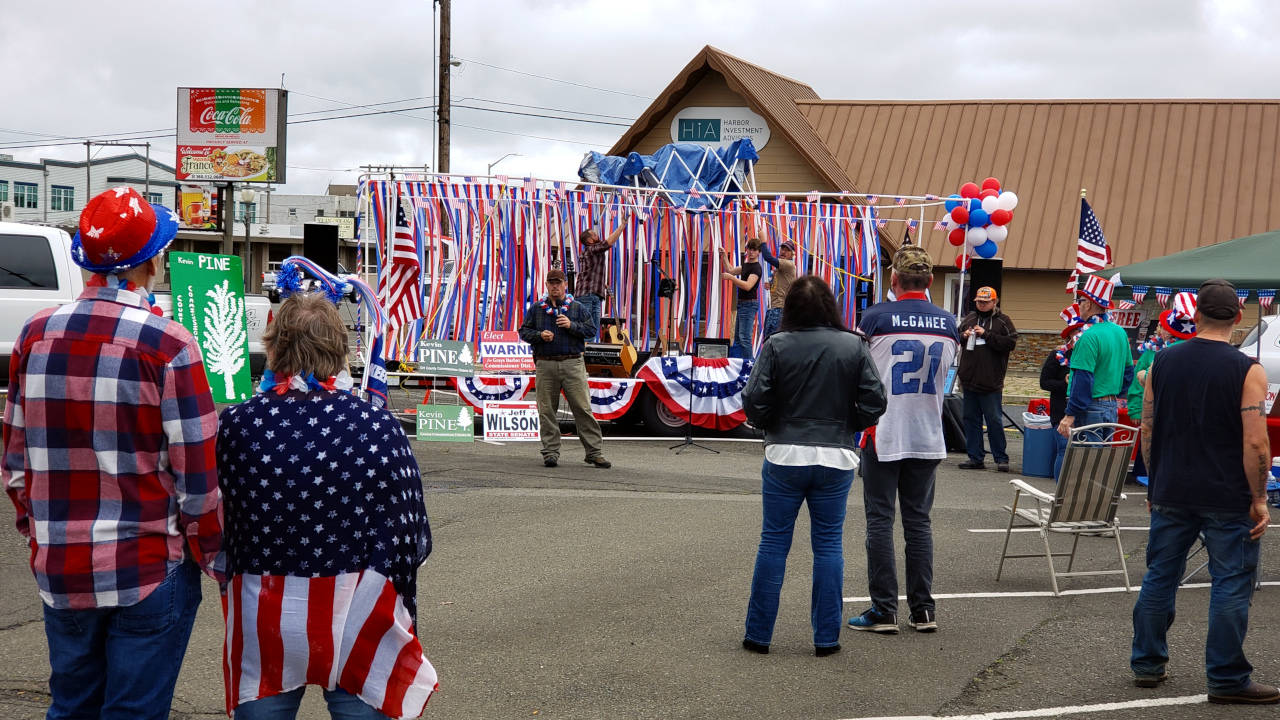 Grays Harbor County Auditor Joe MacLean, middle, addresses the crowd at the Harbor Freedom Rally on Saturday in Aberdeen. (Ryan Sparks | The Daily World)