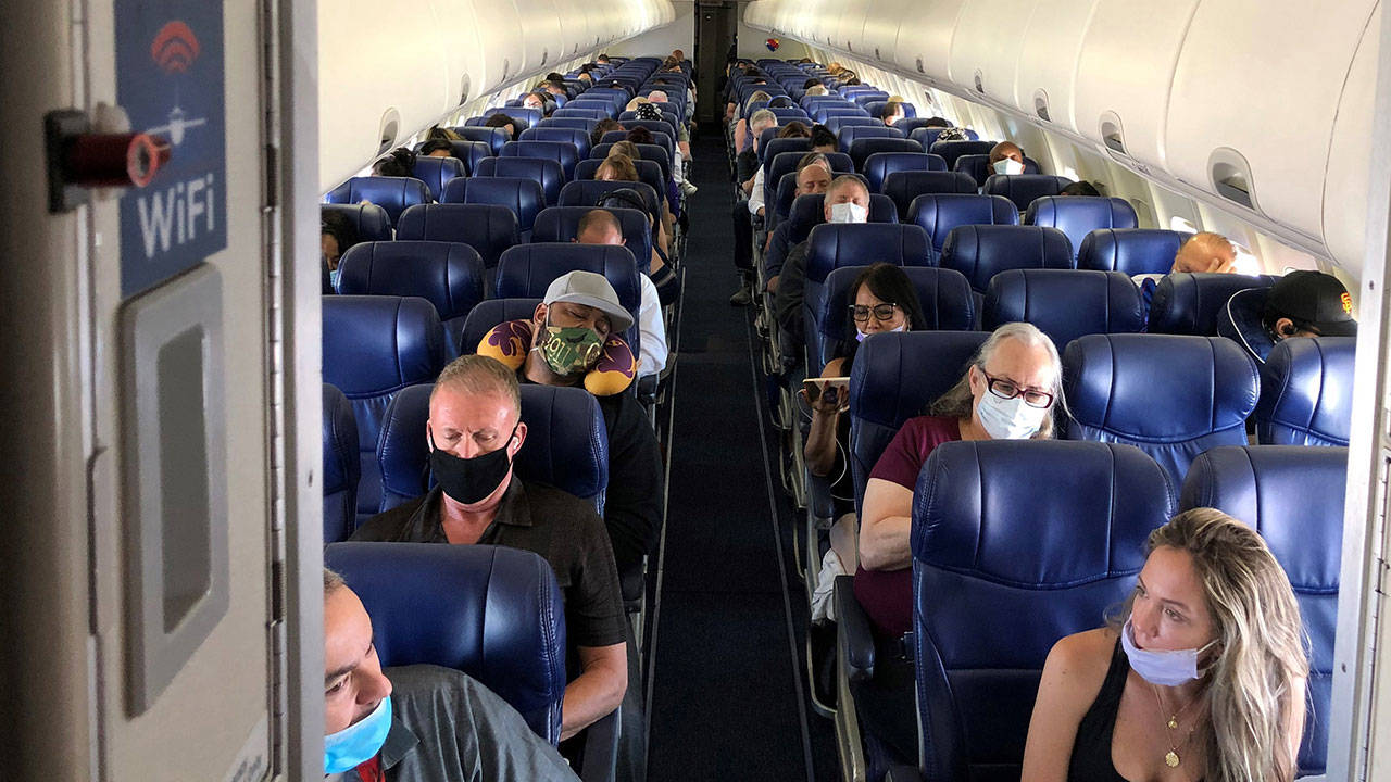Masked passengers fill a Southwest Airlines flight from Burbank, California, to Las Vegas on June 3 with middle seats left open. (Christopher Reynolds/Los Angeles Times)