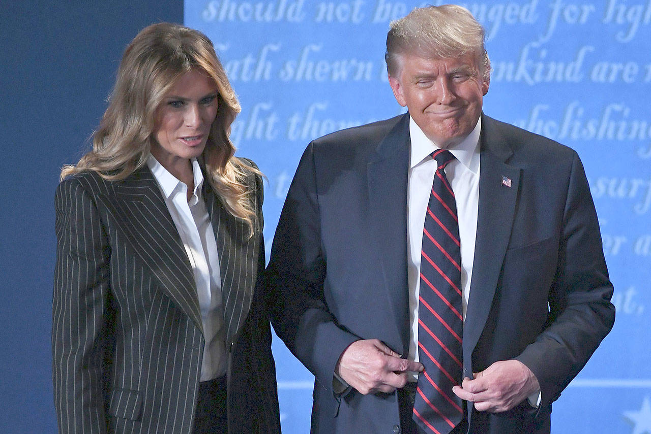 President Donald Trump and First Lady Melania Trump leave after the first presidential debate at Case Western Reserve University in Cleveland on Tuesday. Both are showing “mild symptoms” after testing positive for Covid-19 on Thursday. President Trumps’s age, sex and weight status increases his risk of developing a severe case of COVID-19. (SAUL LOEB/TNS)