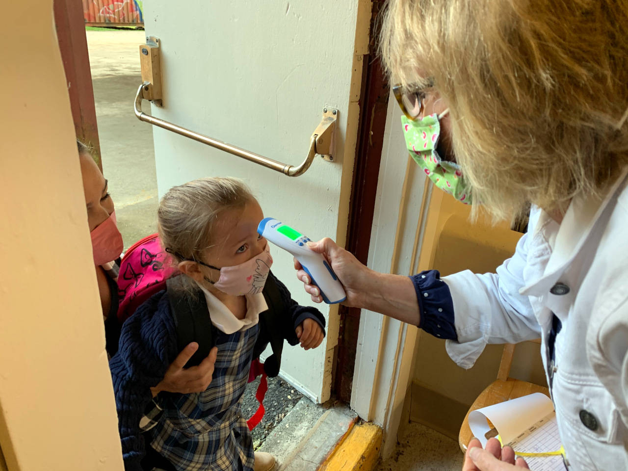 A student has her temperature checked by medical personnel before entering St. Mary School in Aberdeen. (Photo courtesy of St. Mary School)