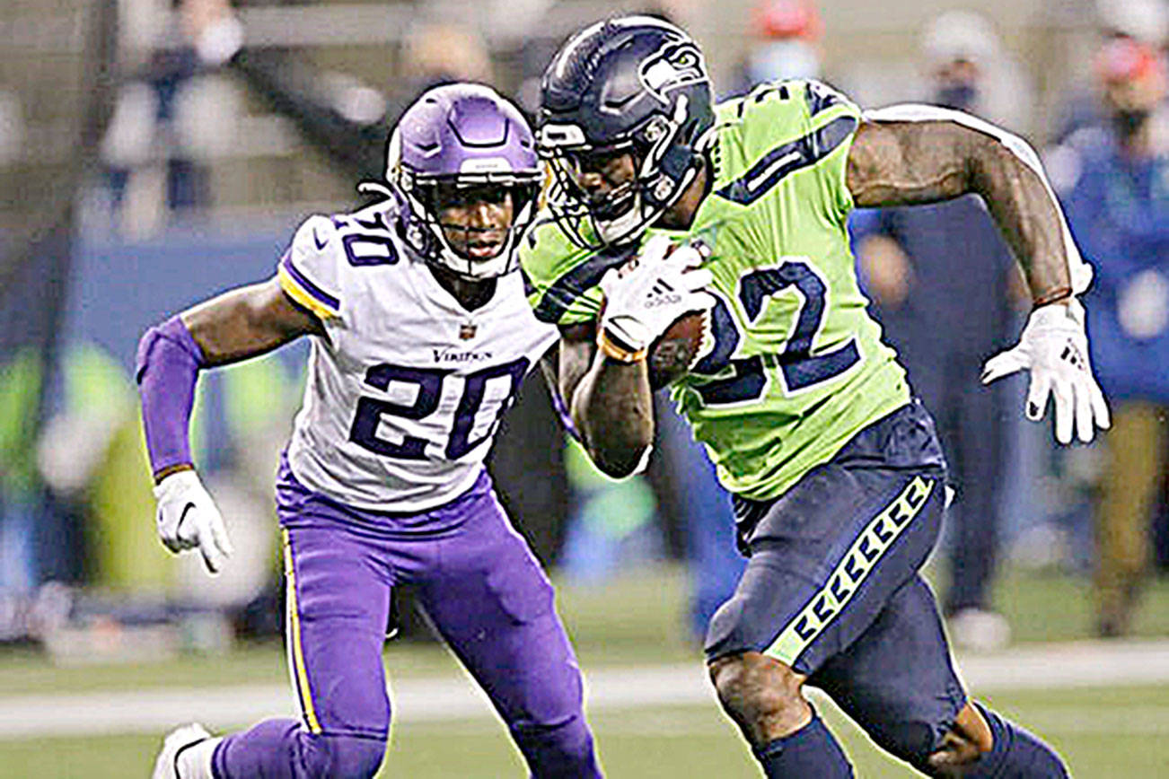 Seattle Seahawk running back Chris Carson rushes for a touchdown as Minnesota's Jeff Gladney gives chase on Oct. 11 in Seattle. (Seattle Times file photo)