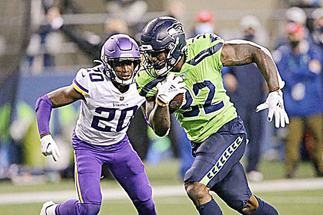 Seattle Seahawks’ Chris Carson rushes for a touchdown as Minnesota Vikings’ Jeff Gladney gives chase during the second half of an NFL football game, Sunday, Oct. 11, 2020, in Seattle.