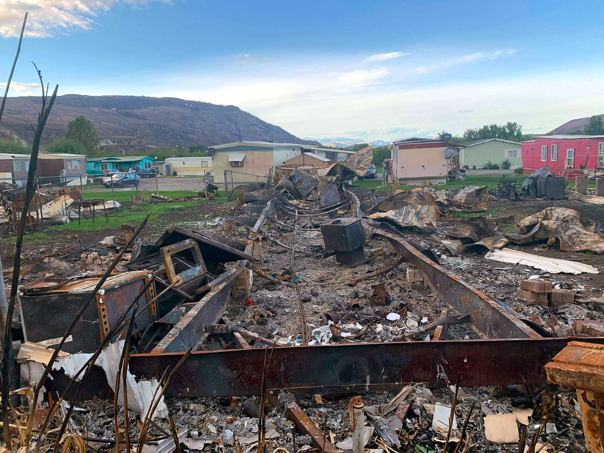 Photo courtesy of Penelope Varn A bent frame is all that is remains of a mobile home in Bridgeport that was ravaged by the Pearl Hill Fire in early September. A local Montesano couple donated a fifth-wheel trailer so the family affected by the fire could avoid homelessness.