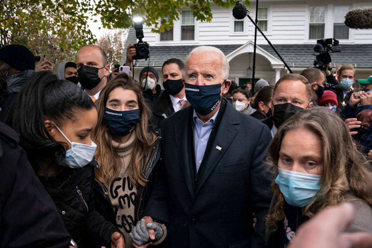 Democratic presidential nominee Joe Biden walks with his granddaughter Natalie Biden as he visits a neighbor&apos;s house after stopping at his childhood home on November 03, 2020 in Scranton, Pennsylvania. As polls open on Election Day, nearly 100 million Americans have already cast their ballots through early voting and mail-in voting. (Photo by Drew Angerer/Getty Images/TNS)