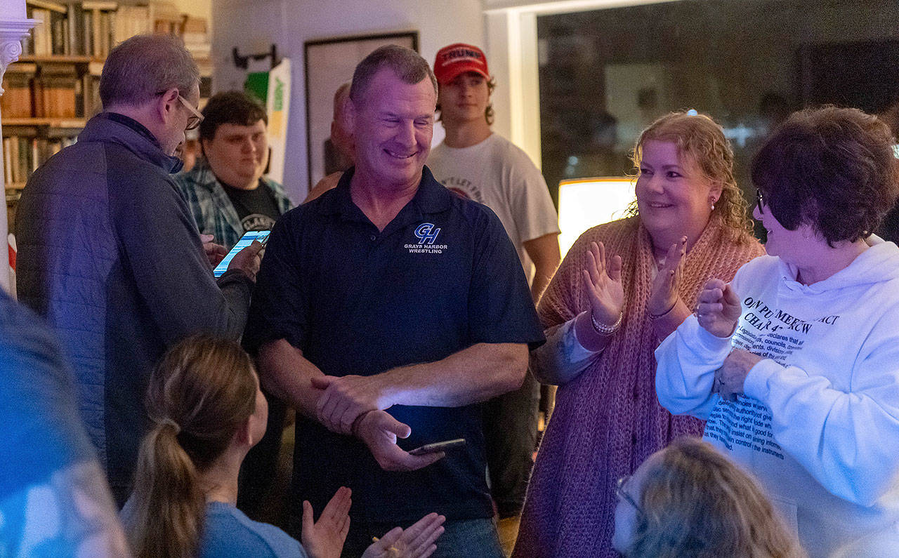 PHOTO BY JIM THRALL Kevin Pine, middle, in congratulated after election night results showed him in the lead in the race for Grays Harbor County Commissioner Seat 2 against incumbent Randy Ross.