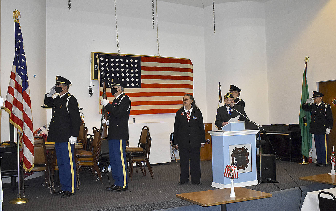 DAN HAMMOCK | THE DAILY WORLD 
The presentation of the colors at the Aberdeen VFW post Wednesday, Veteran’s Day. At the podium are auxiliary president Jo Ann Wadsworth and post commander Anthony Magri, who served in the Navy for 25 years.