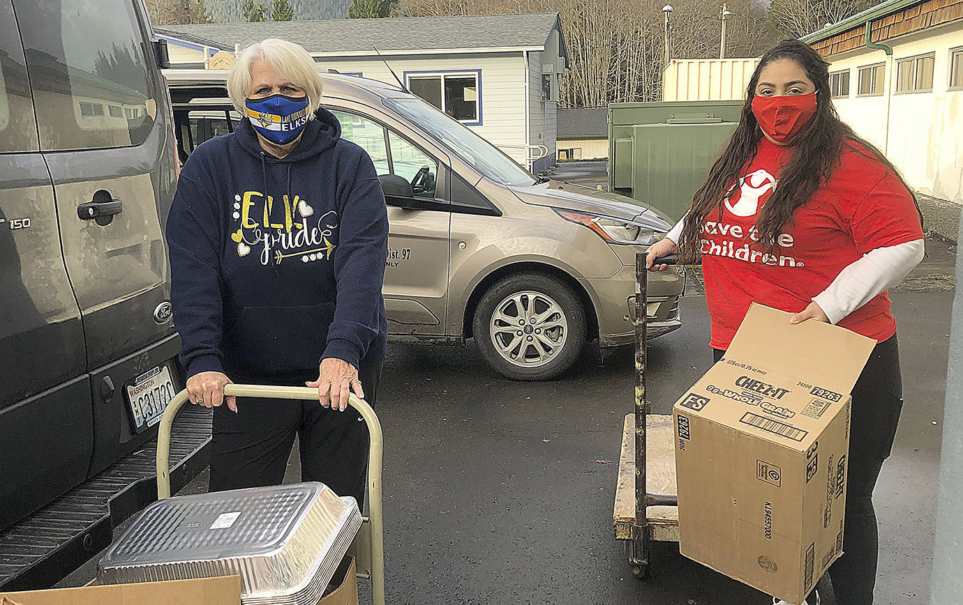 photos COURTESY SAVE THE CHILDREN 
Lake Quinault School Home and Career teacher Barb Marshall, left, and Save the Children Early Childhood Education Coordinator Marisol Castillo load up Thanksgiving meals before delivering them to children and families in the Lake Quinault Community.