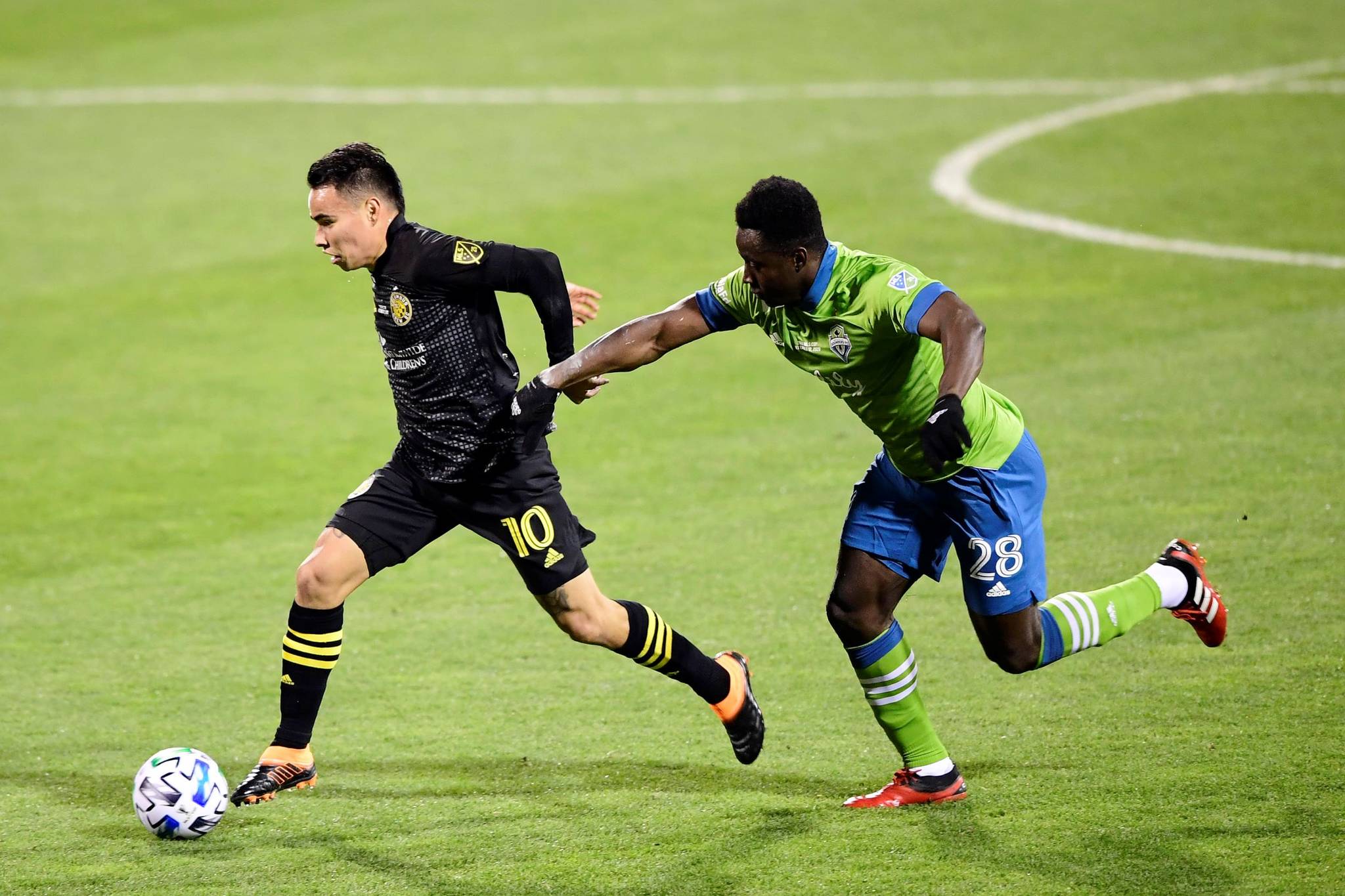 Emilee Chinn/Getty Images 
Lucas Zelarayan, left, of the Columbus Crew controls the ball against Yeimar Gomez of the Seattle Sounders in the first half during the MLS Cup Final at MAPFRE Stadium on Saturday in Columbus, Ohio. The Crew one the game, 3-0.