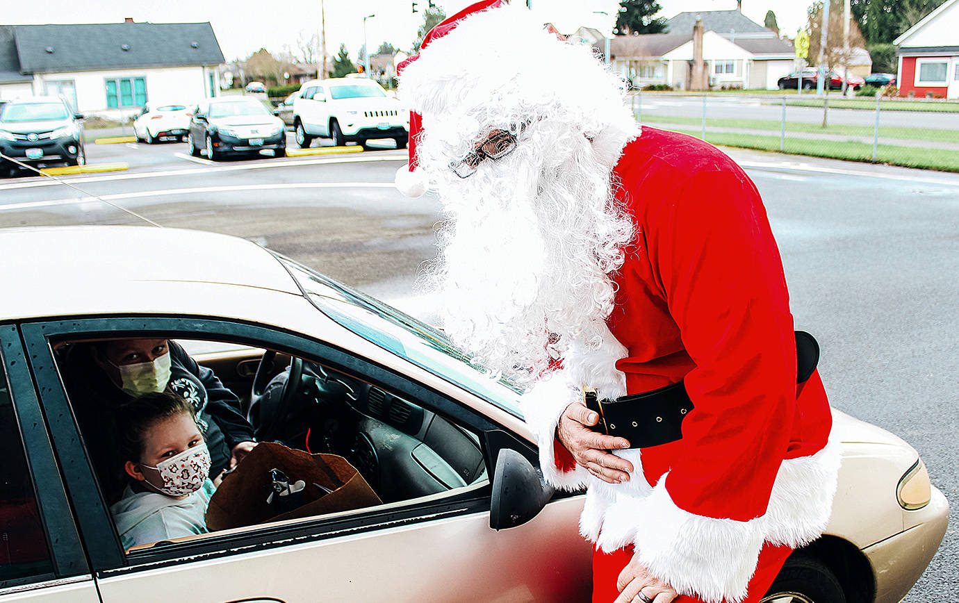 Kailyn Jackson and Sara Zillyette with Santa at Emerson Elementary’s drive through Santa event Tuesday. COURTESY PHOTO