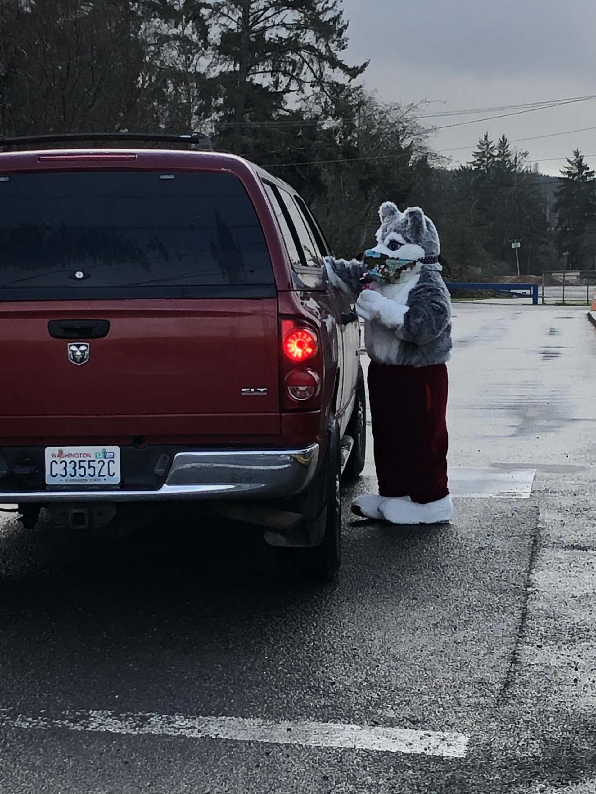 Santa Husky hands out treats at Stevens Elementary School. Over 150 students came for the social distance drive-by Santa Husky and his helpers.