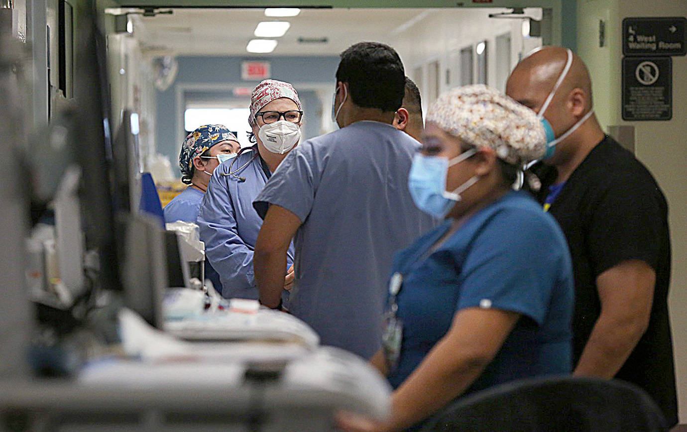Dania Maxwell / Los Angeles Times 
Hospital doctors and nurses treat COVID-19 patients in a makeshift ICU wing Dec. 29 at Harbor UCLA Medical Center in Torrance, California.