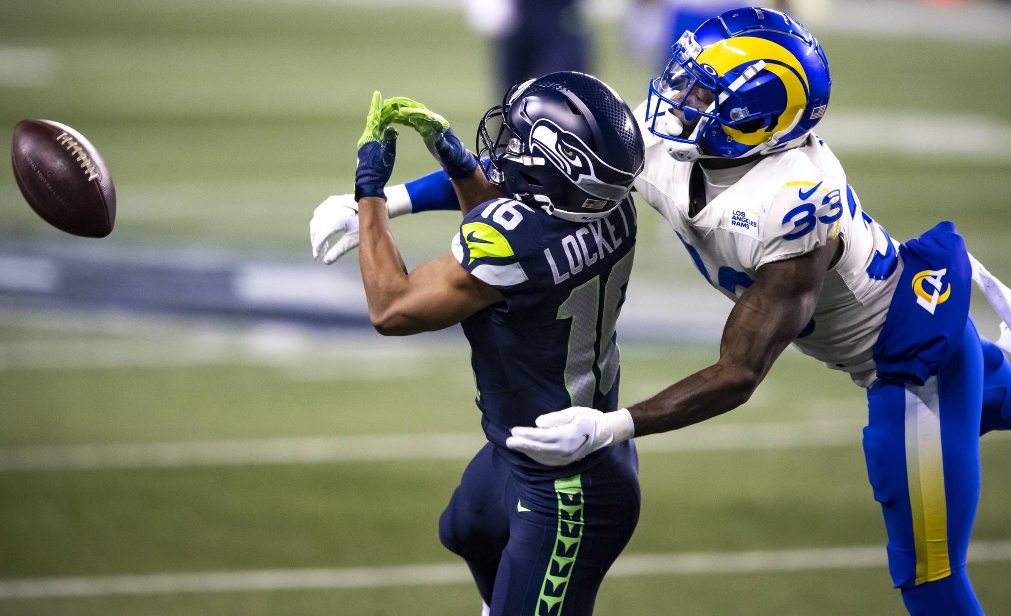 Bettina Hansen/Seattle Times 
On third down, this long pass to Seattle Seahawks wide receiver Tyler Lockett falls incomplete against Rams safety Nick Scott in the final minutes of the game during the Wild Card round of the NFL Playoffs on Saturday at Lumen Field in Seattle.