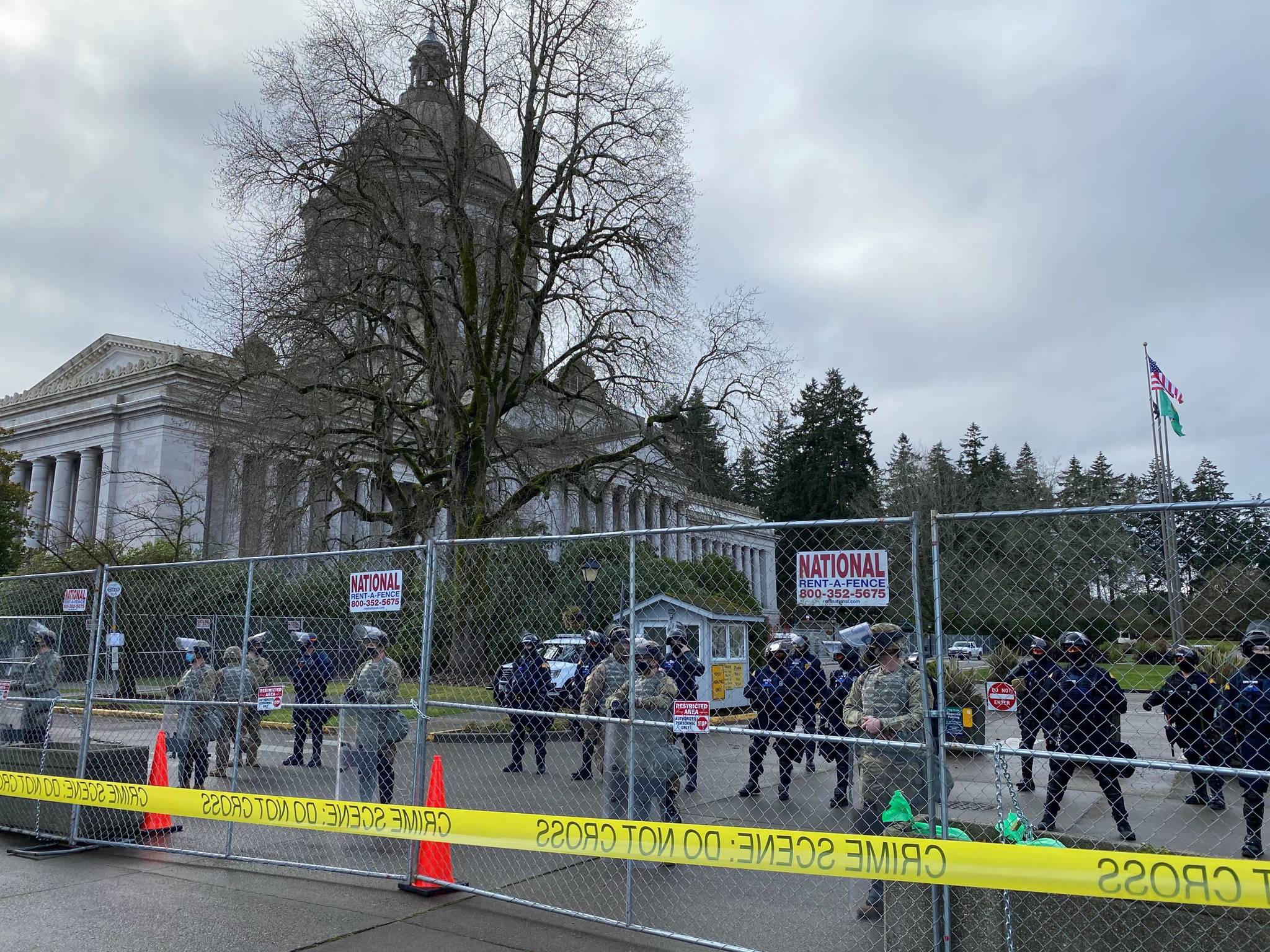 Richard Read/Los Angeles Times 
National Guard troops backed by state troopers guard a fenced-off Washington state Capitol in Olympia on Jan. 10.