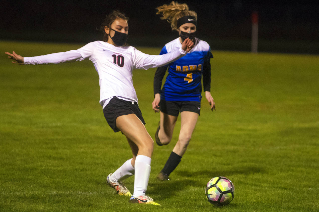 Ocosta’s Liveah Bartley, left, makes a pass while being defended by Adna’s Jordyn Swenson on Wednesday in Adna. (Eric Trent | The Chronicle)
