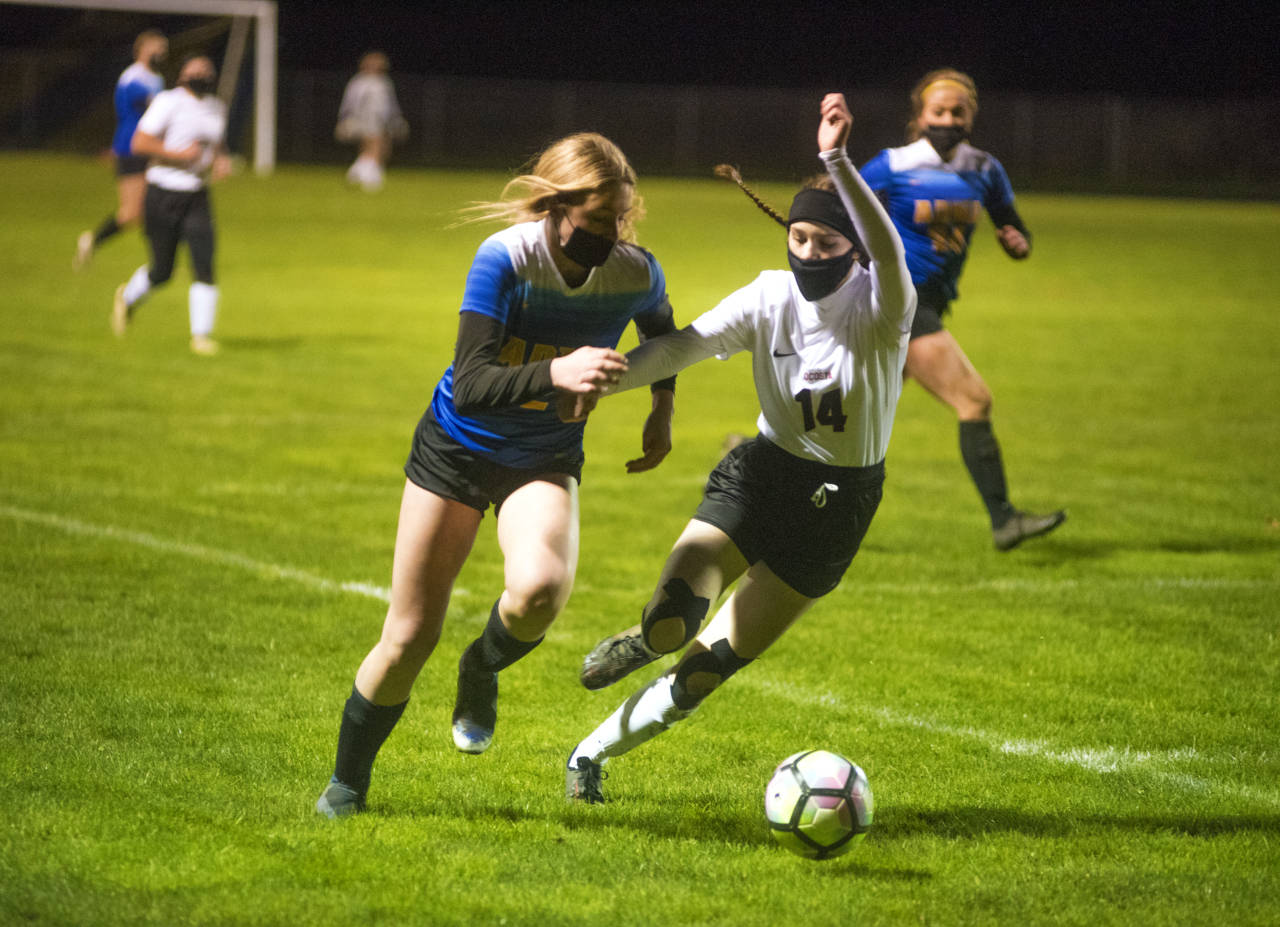 Ocosta defender Maia Soderlund, right, battles with Adna forward Summer White during Ocosta’s 2-1 loss on Wednesday in Adna. (Eric Trent | The Chronicle)