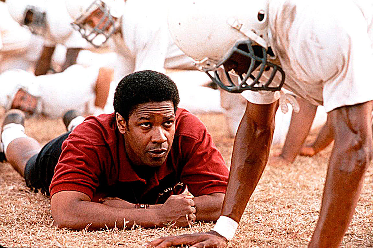 Denzel Washington starred as coach Herman Boone, who leads a Virginia high school’s first integrated football team in 1971 in “Remember the Titans.” (TNS file photo)