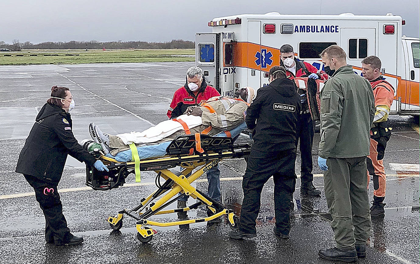 COAST GUARD SECTOR COLUMBIA RIVER PHOTO 
A man is tended to by EMS after a Coast Guard helicopter crew plucked him from a vessel 60 miles off Grays Harbor Thursday. The man was suffering from a head laceration.