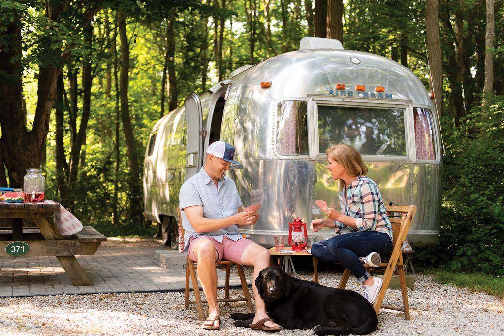 Photo by Mia Campopiano/TNS 
Brian and Liz Hickox and their Lab mix, Salty, camp in an Airstream travel trailer at Melville Ponds Campground in Portsmouth, Rhode Island.
