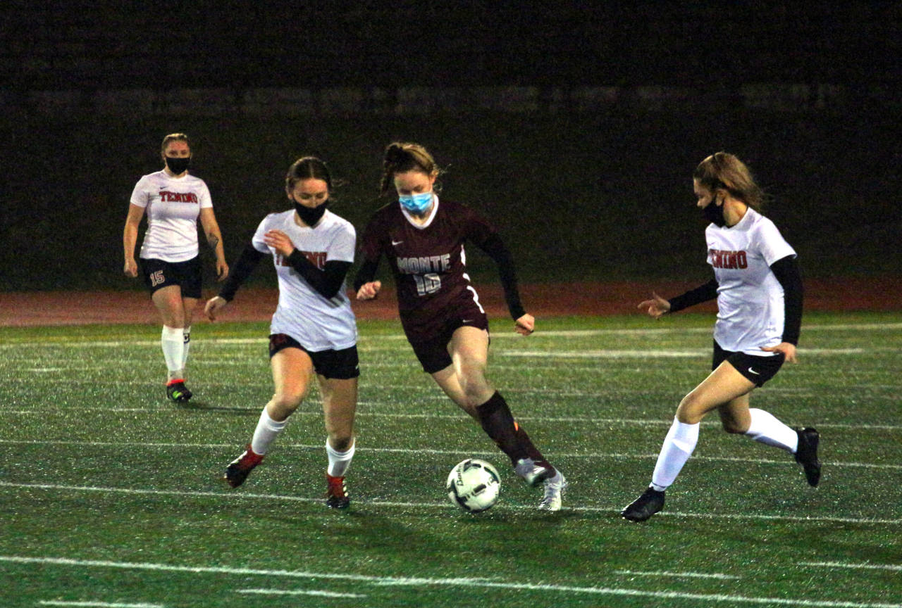 Montesano midfielder Brooke Streeter (10) splits two Tenino defenders during the Bulldogs’ 3-2 loss on Thursday at Jack Rottle Field in Montesano. (Ryan Sparks | The Daily World)