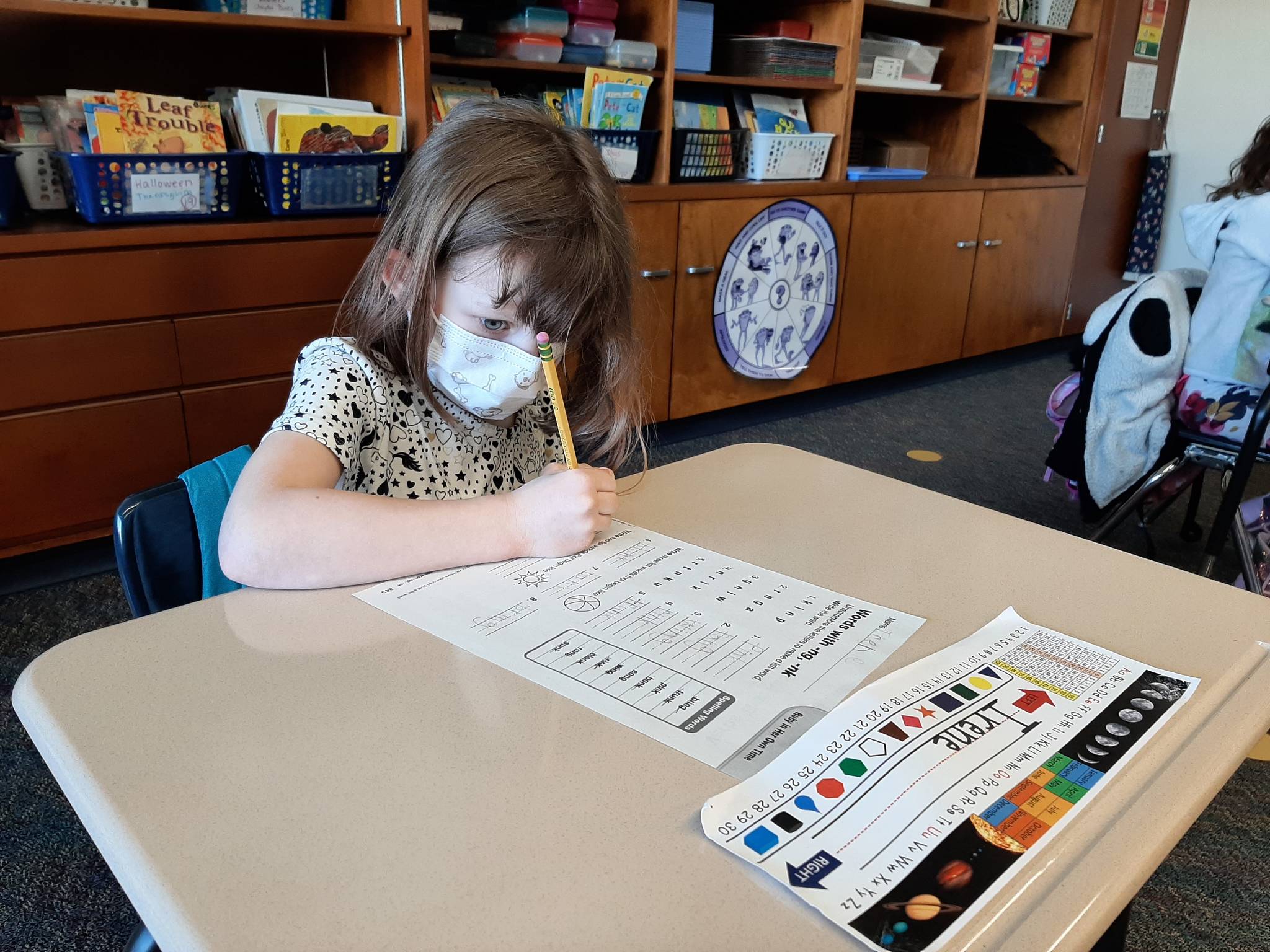 First-grade student Irene Nelson works diligently on her assignment. (Photo By Cherie Patterson)