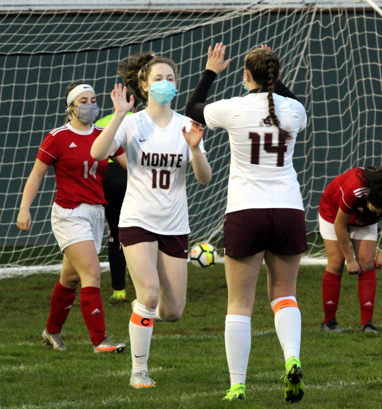 Montesano midfielder Brooke Streeter (10) is congratulated by teammate Cassadie Golding after scoring one of her two goals in a 4-0 win over Hoquiam on Thursday in Hoquiam. Streeter became a member of the 50/50 club with 50 goals and 54 assists for her prep career. (Photo by Ben Winkelman)