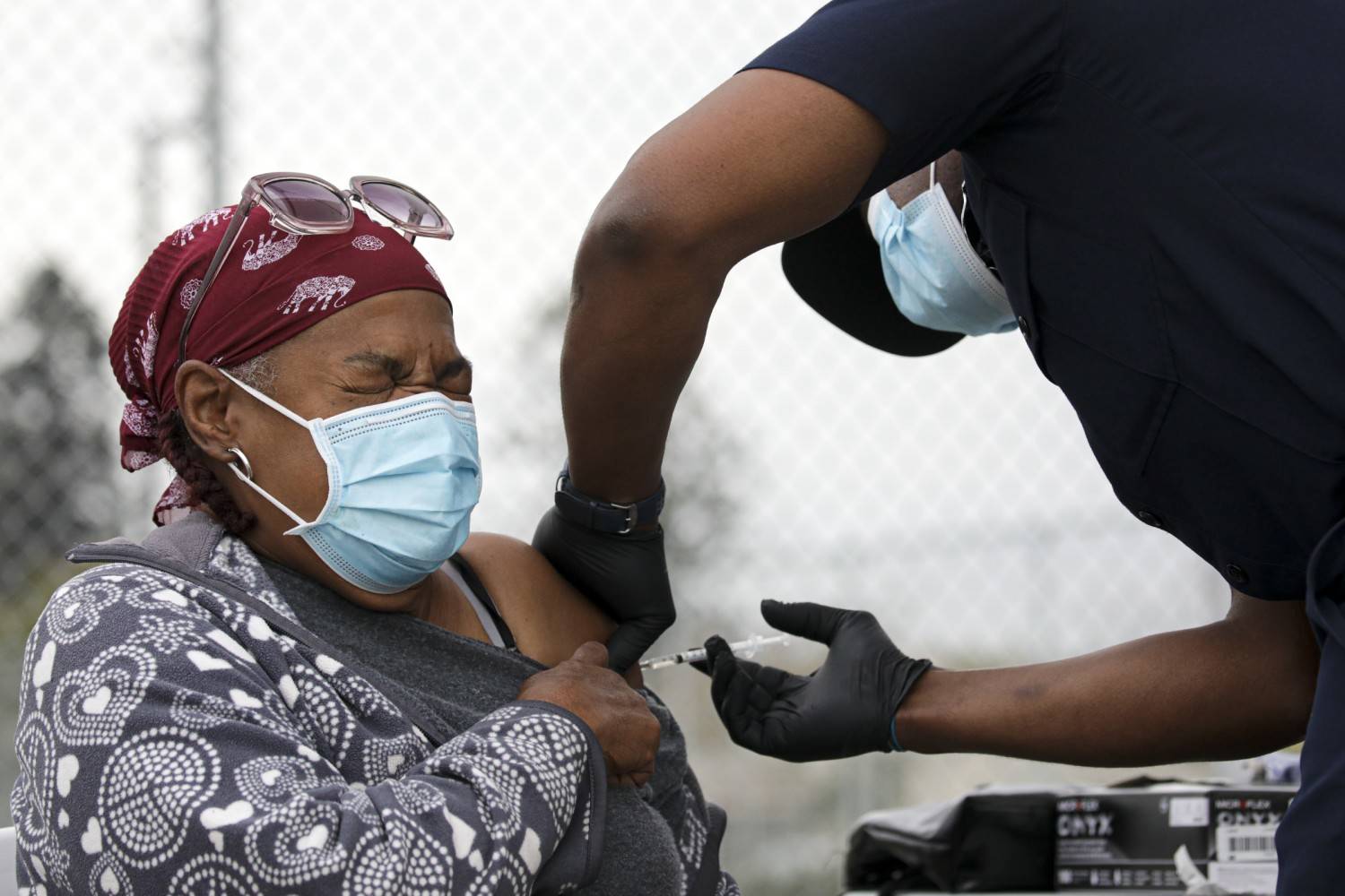 Irfan Khan / Los Angeles Times
Los Angeles firefighter Dion Cooper administers a COVID-19 vaccine to Marilyn Shugars,71, at a mobile vaccination site in Los Angeles. As more Americans line up for the COVID-19 vaccine, some are anxious about the second-dose side effects, which tend to be stronger than the first.