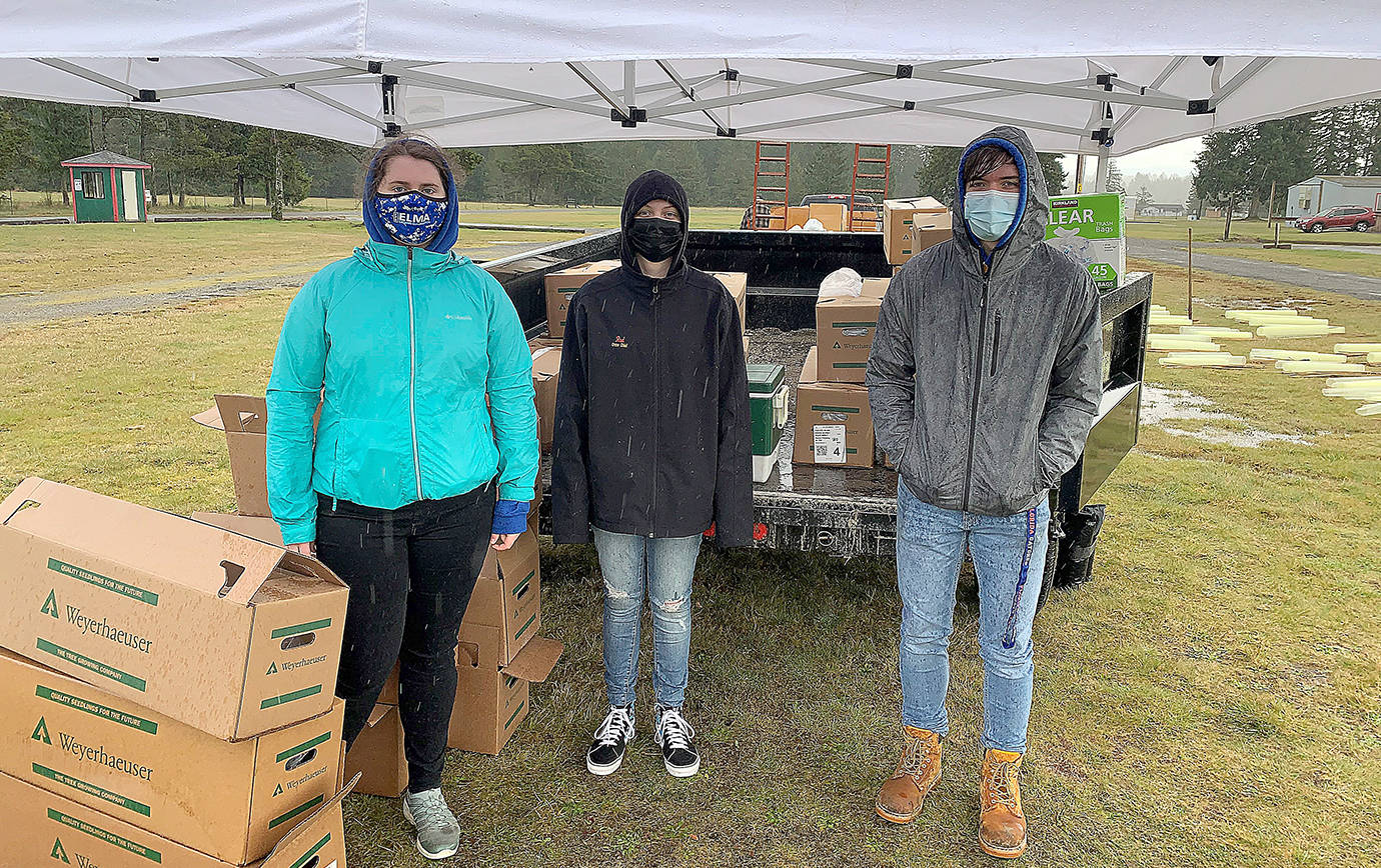 TYLER RENZ | ELMA FFA ADVISOR 
Elma FFA members helped distribute 1,700 California redwood and giant sequoia seedlings at a PropagationNation giveaway at the Elma Fairgrounds March 20 and 21. Pictured from left are Alyssa Pearson, Skyler Putt and Sam Gillis.