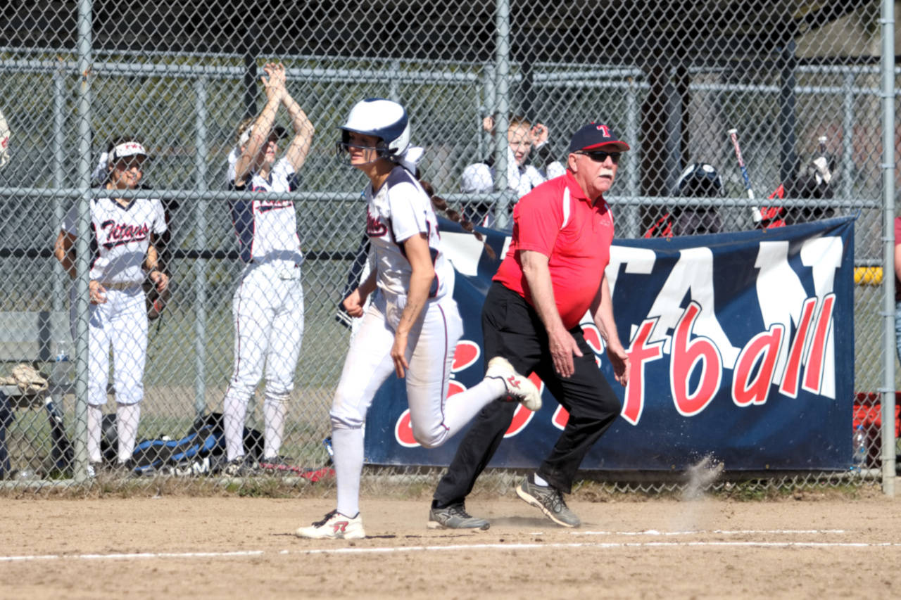 RYAN SPARKS | THE DAILY WORLD PWV head coach Ken Olson waves Annika Mason home to score during the first game of a doubleheader against Ocosta on Tuesday at Pe Ell High School.
