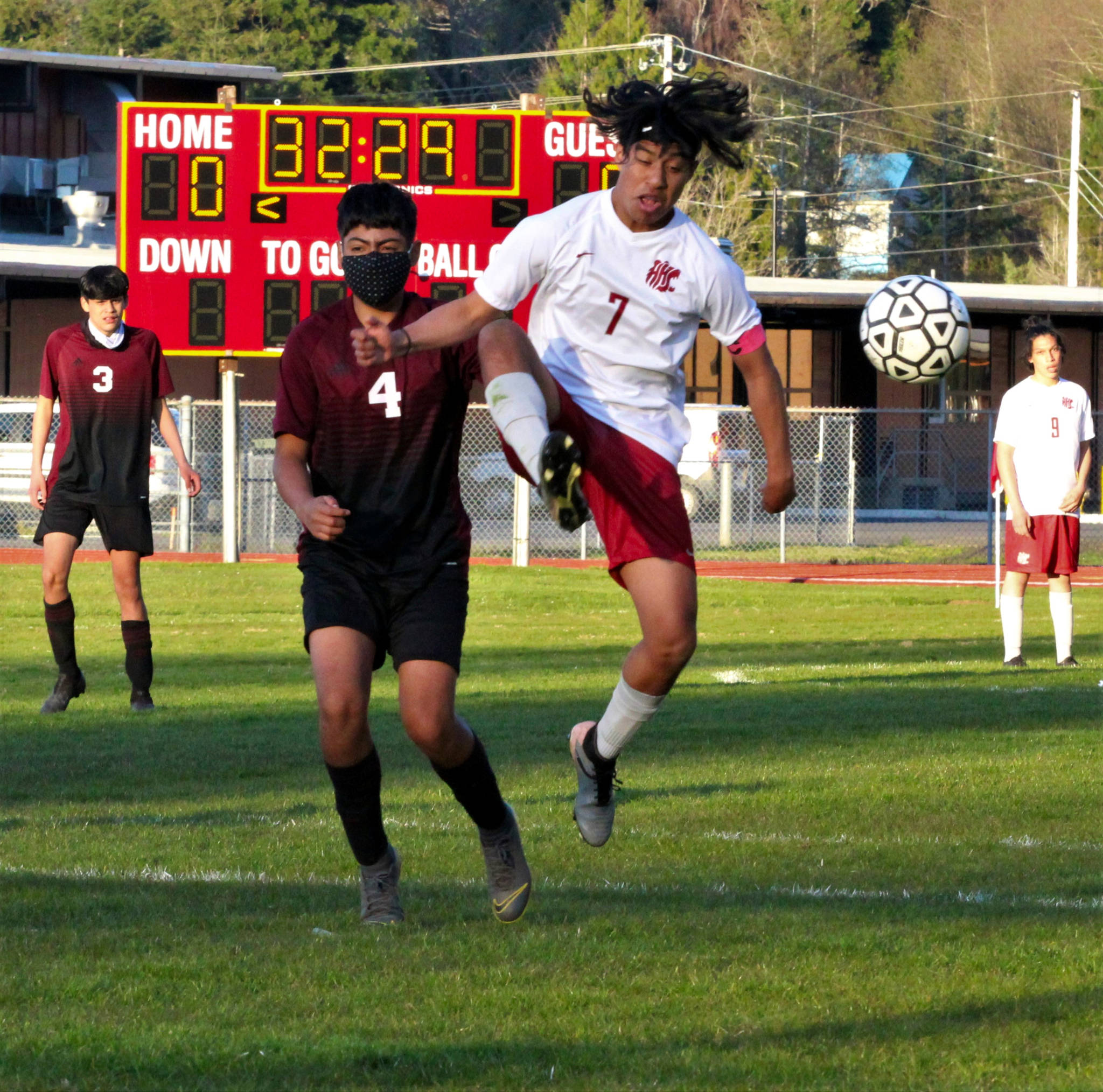 PHOTO BY BEN WINKELMAN 
Hoquiam midfielder Kevin Catalan (7) leaps to make a play against Raymond-South Bend’s Christopher Quintana Silva in Hoquiam’s 4-3 victory on Tuesday in Hoquiam.