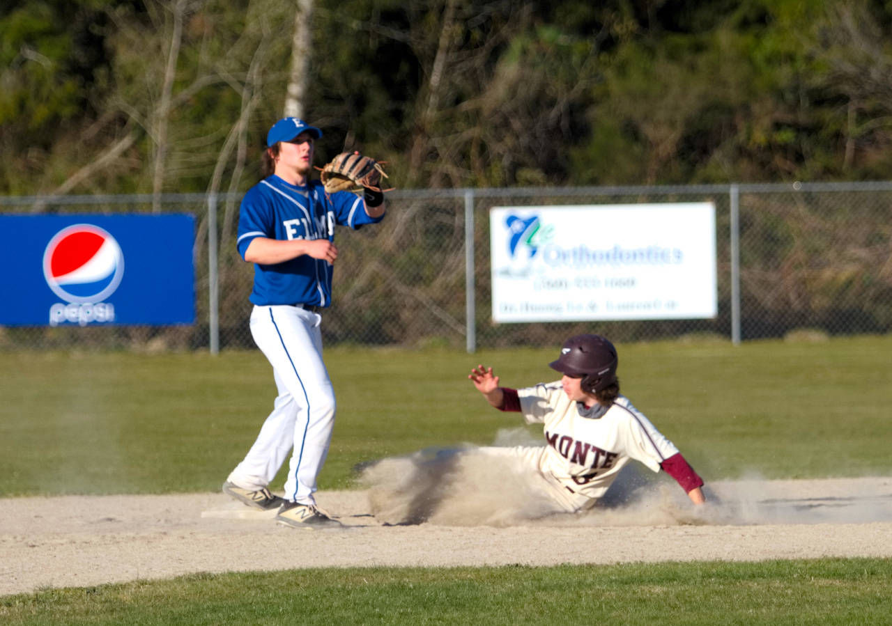 RYAN SPARKS | THE DAILY WORLD Montesano’s Christian Prall slides into second while Elma infielder Brody Rustemeyer awaits the throw in Monte’s 13-11 extra-inning victory on Friday in Elma.