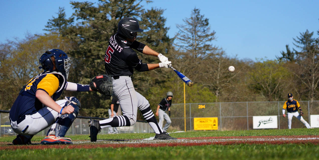 PHOTO BY ROB HILSON Ocosta’s Harley Figueroa belts and RBI single to center field during Ocosta’s 13-9 loss to Ilwaco on Friday in Long Beach.