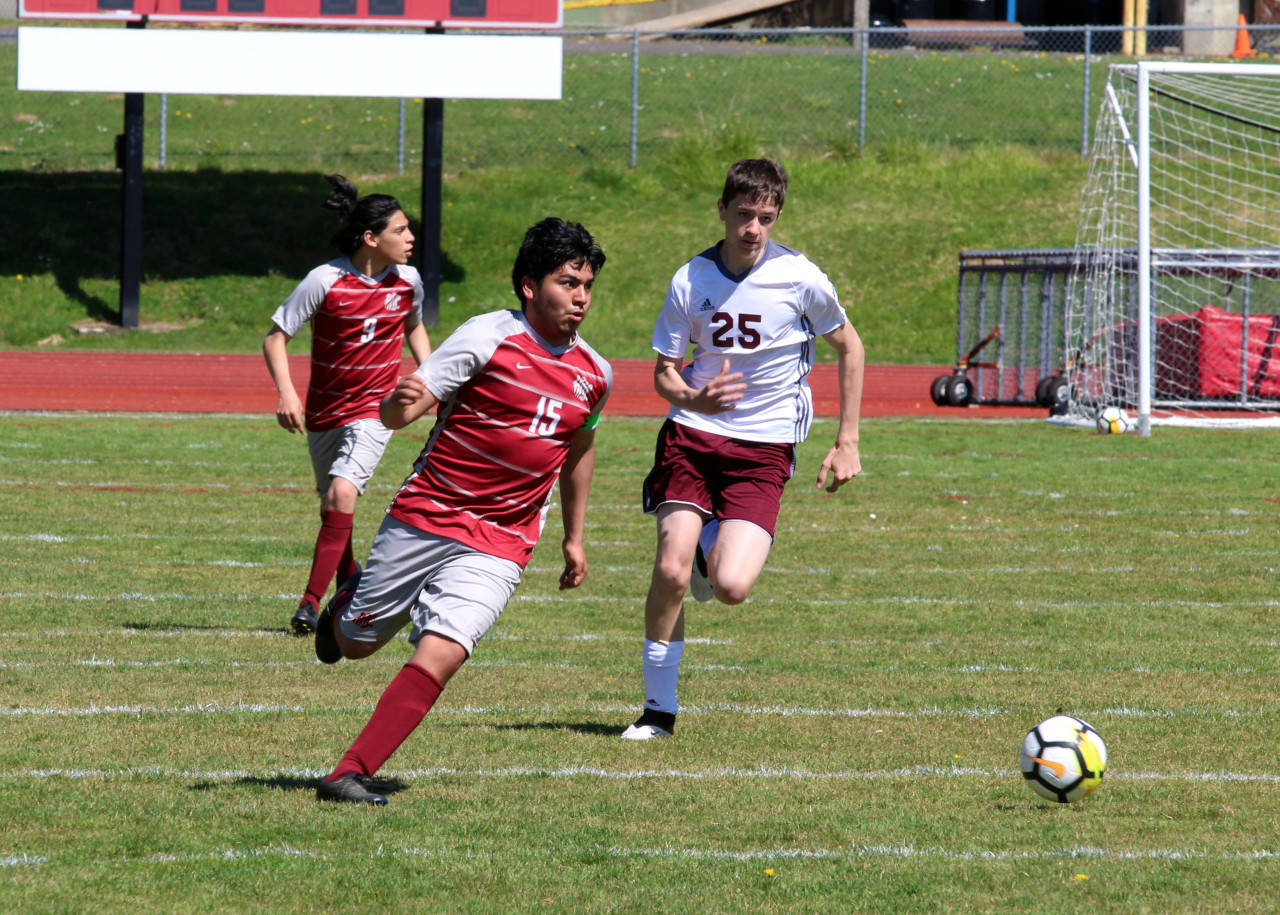 PHOTO BY BEN WINKELMAN Hoquiam midfielder Daniel Cortes (15) is pursued by Montesano’s Levi Clements during the Bulldogs’ 3-2 victory Saturday at Sea Breeze Oval in Hoquiam.