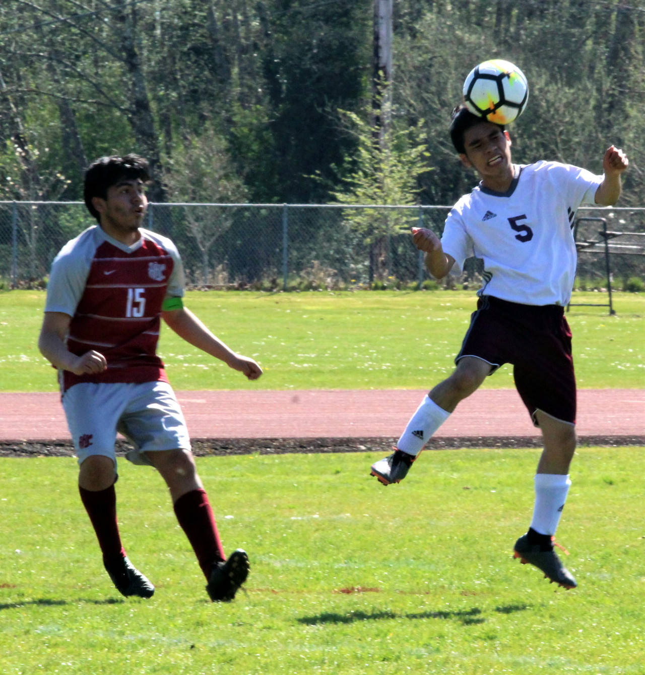 PHOTO BY BEN WINKELMAN Montesano’s Yased Ramirez (5) gets a head on the ball in front of Hoquiam’s Daniel Cortes during a game on Saturday in Hoquiam.