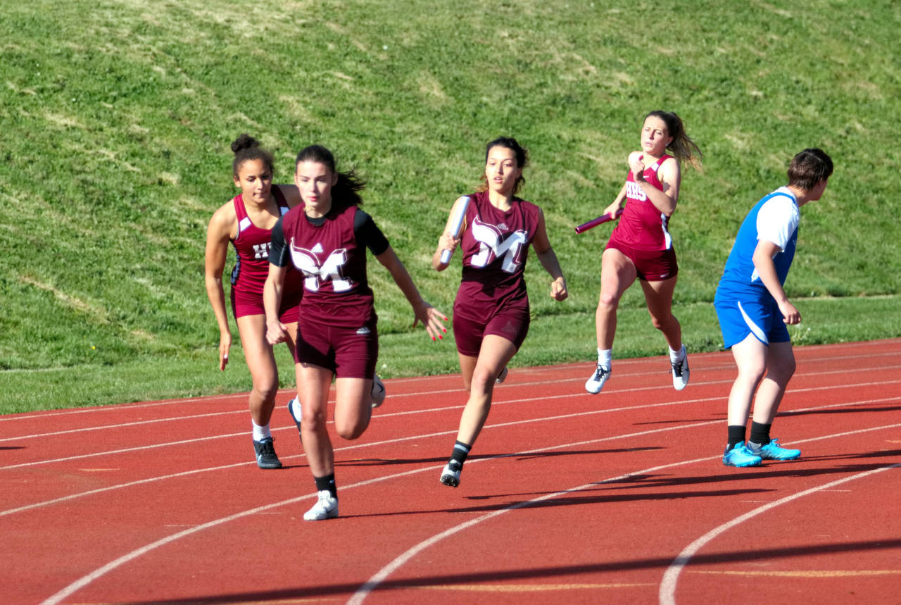 RYAN SPARKS | THE DAILY WORLD
Montesano anchor Jaiden Morrison, foreground, takes the baton from teammate Alma Muro during the girls 4x100 relay at the 1A Evergreen League Championships on Thursday at Jack Rottle Field in Montesano.